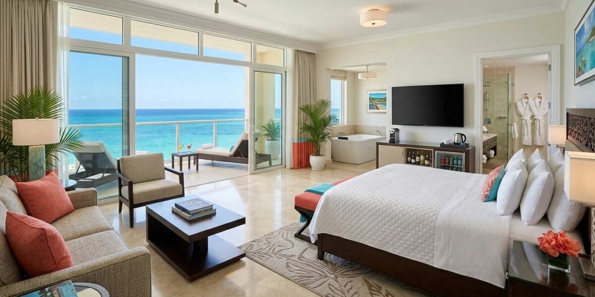 Jewel Grande Montego Bay Resort luxury suite with ocean-view balcony, king bed, and upscale Caribbean-inspired amenities.